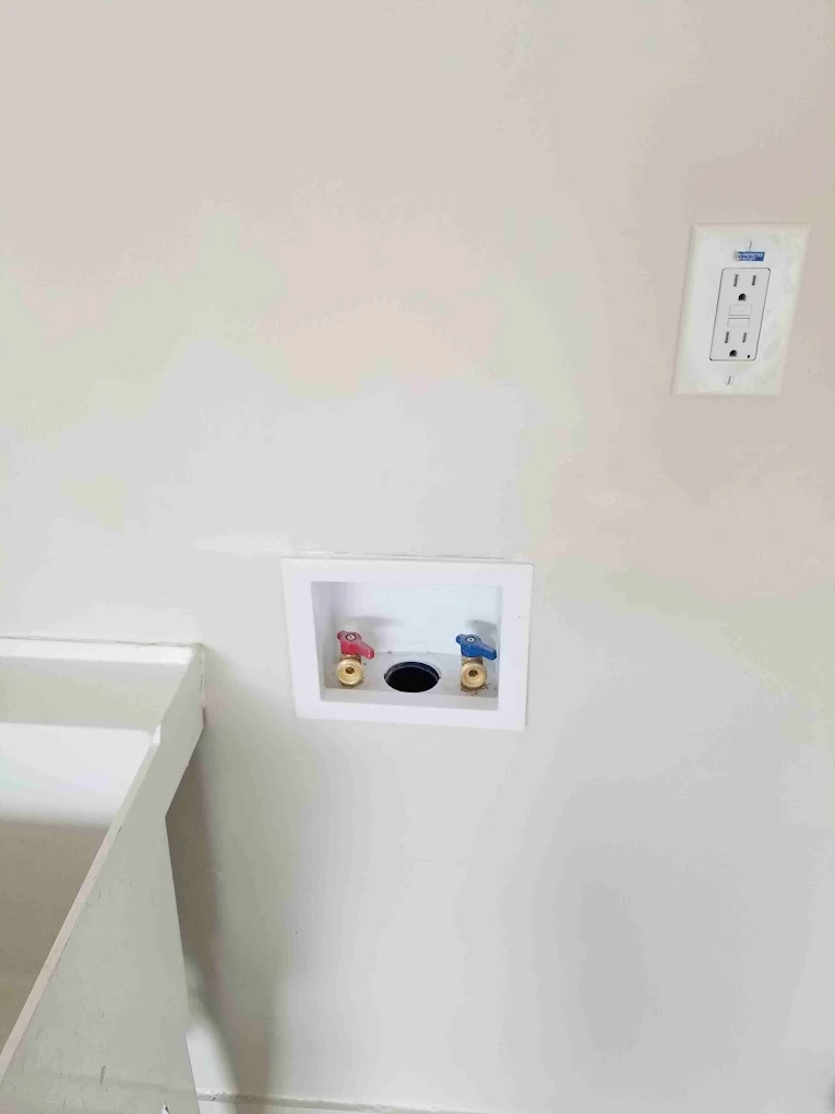 Bathroom wall with water shutoff valve box and electrical outlet